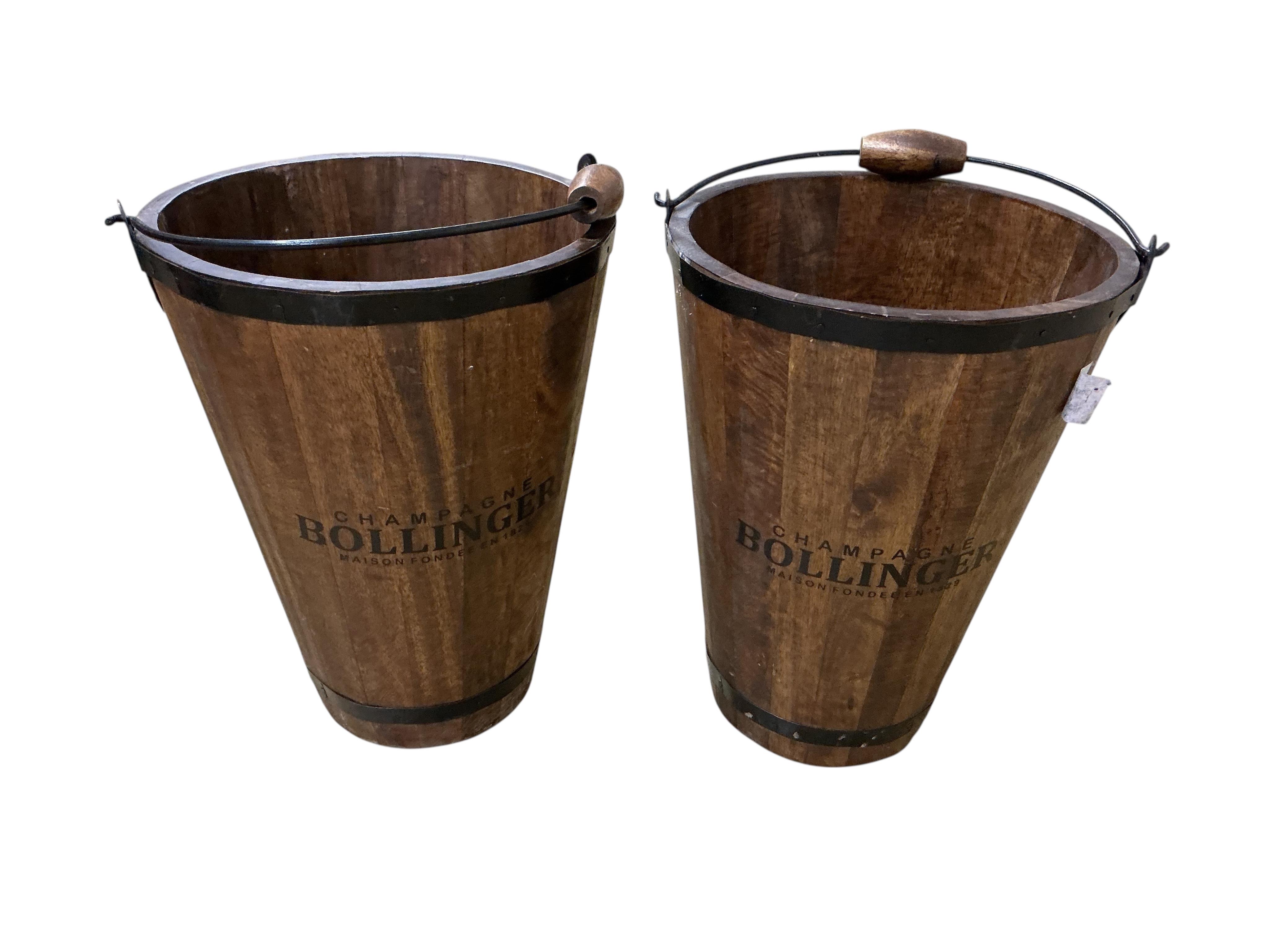 A pair of staved wood champagne buckets stencilled “Bollinger”, height 39cm.